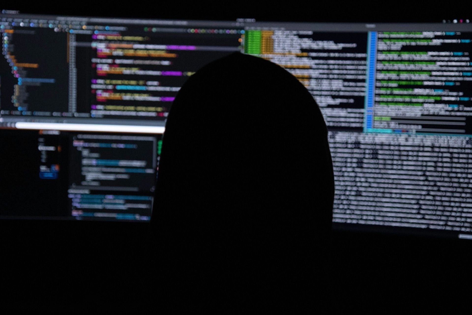 Flat screen monitor turned on in a dark room displaying a development environment interface